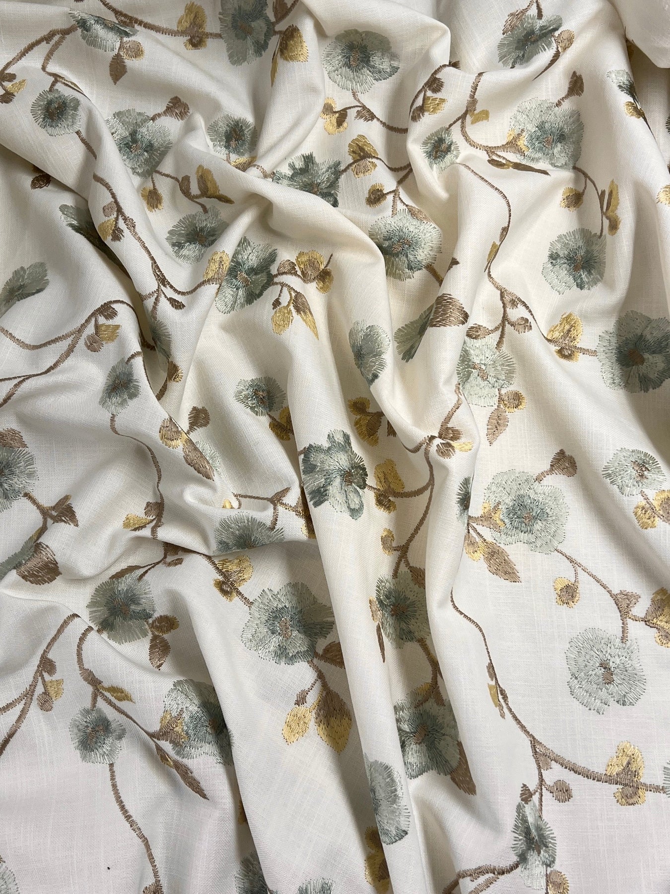 Imported, luxury interior design brand linen fabric featuring intricate botanical embroidery