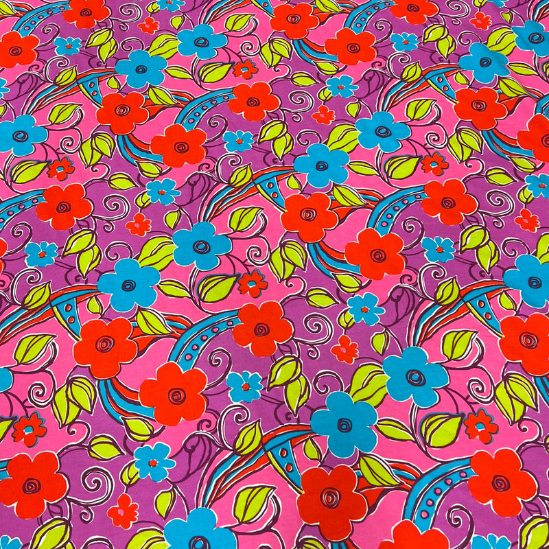 Lightweight cotton french terry featuring a vibrant floral pattern in colors pink, purple, and blue