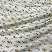 Cotton rib knit featuring small format design of simple Christmas trees. 