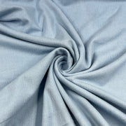 Close-up of light blue fabric with a swirl pattern