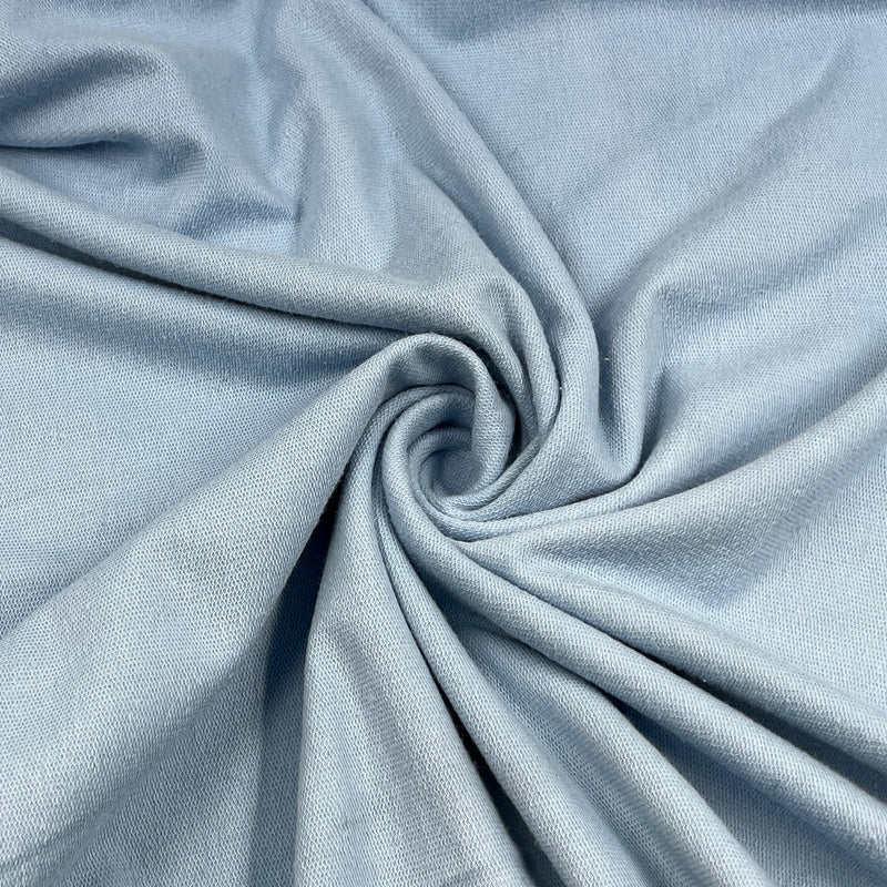 Close-up of light blue fabric with a swirl pattern
