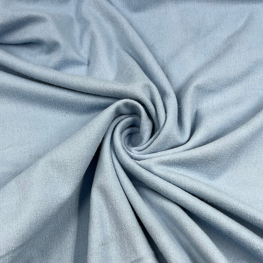 Close-up of light blue fabric with a swirl pattern