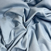 Close-up of light blue fabric with folds