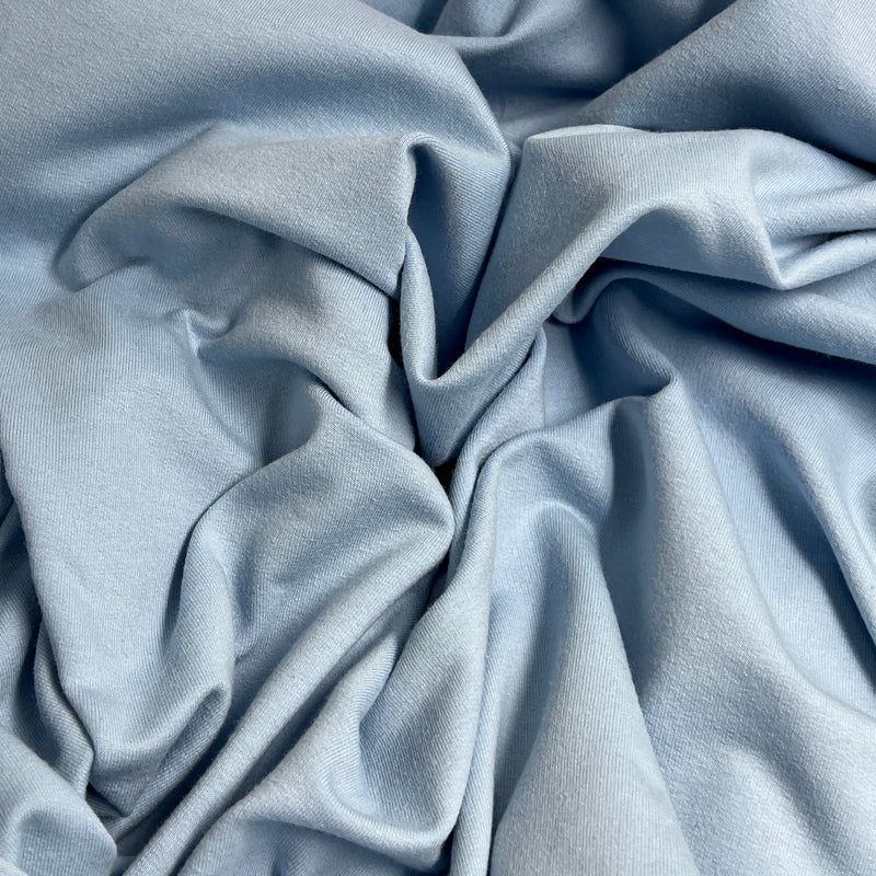 Close-up of light blue fabric with folds