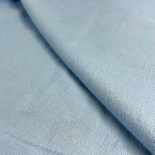 Close-up of light blue fabric with a subtle texture