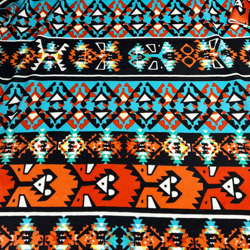 Patterned fabric with geometric design in orange, blue, and black.