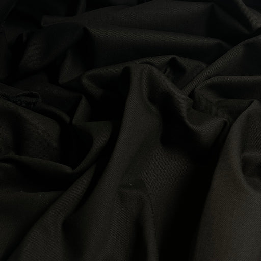 Black bull denim bunched and puled into a bundle