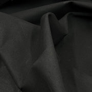 Closeup of black cotton canvas draped freely. 