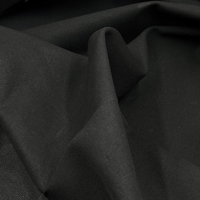 Closeup of black cotton canvas draped freely. 