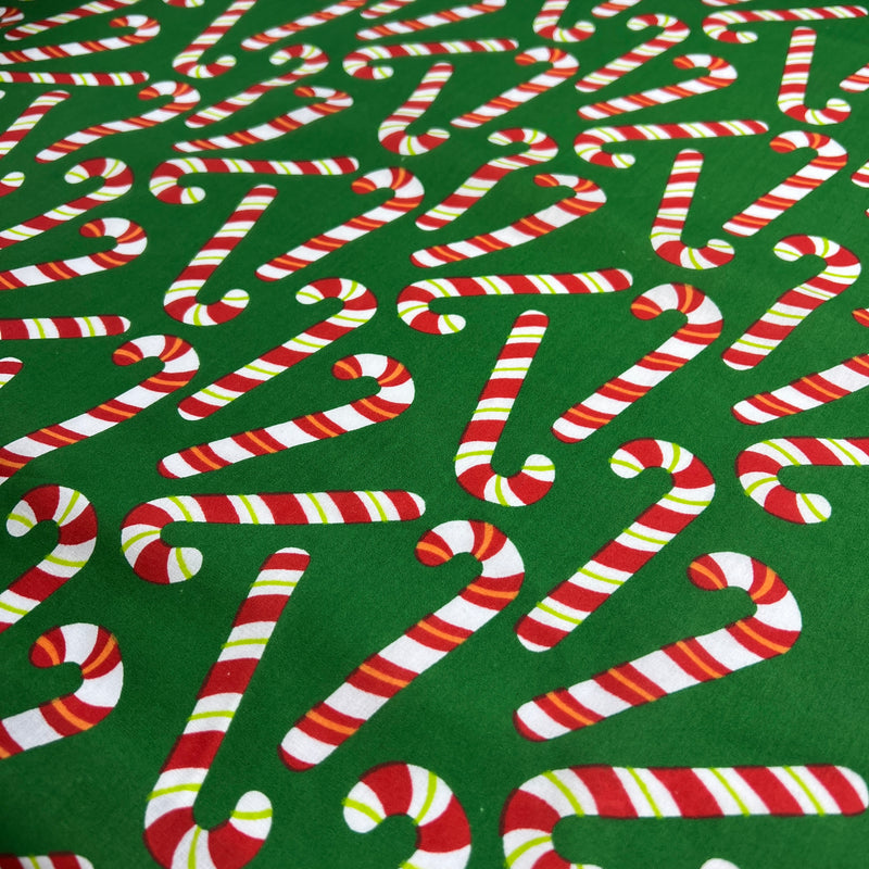 Pattern of candy canes on a green background