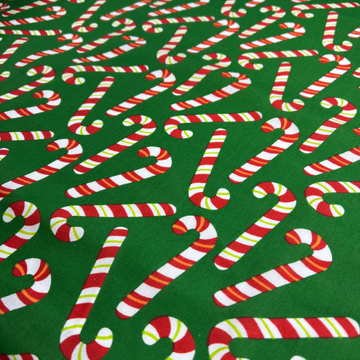 Pattern of candy canes on a green background