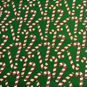 Pattern of candy canes on a green background