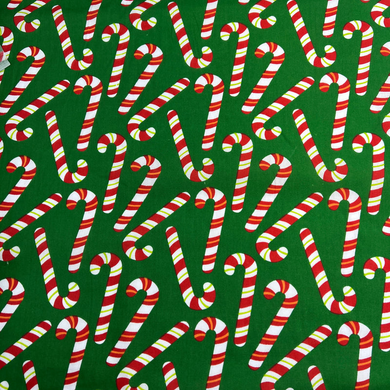 Pattern of candy canes on a green background