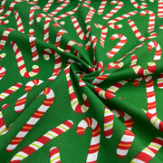Fabric with candy cane pattern on a green background