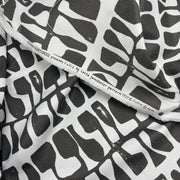 Black and white patterned fabric with visible brand name on a white background