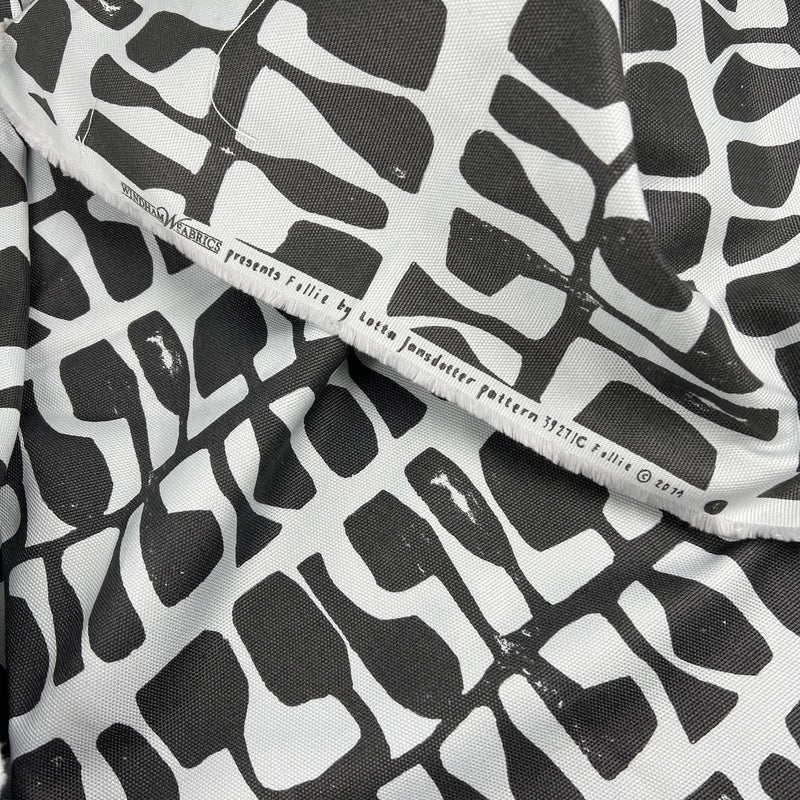 Black and white patterned fabric with visible brand name on a white background
