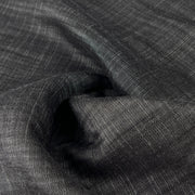 Close-up of dark charcoal grey 100% tencel denim with subtle sheen and a fine twill weave