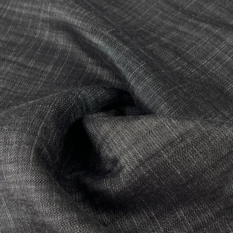 Close-up of dark charcoal grey 100% tencel denim with subtle sheen and a fine twill weave