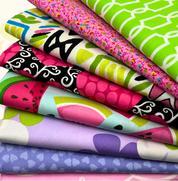 Stack of colorful fabric swatches with various patterns