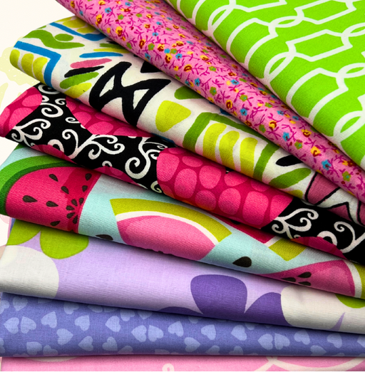 Stack of colorful fabric swatches with various patterns