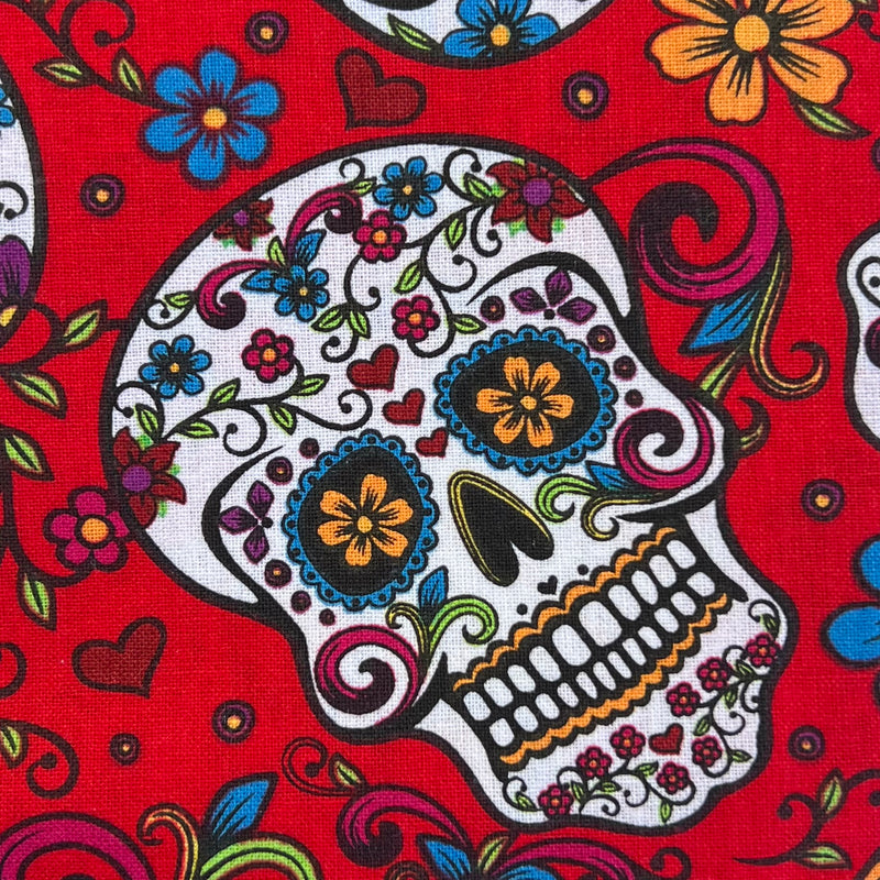 Quilting Cotton fabric with spanish Dia De Muertos print on red background