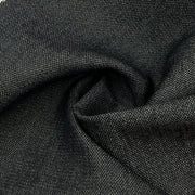 closeup of the face of a dark indigo broken twill weave denim showing the rich depth of color