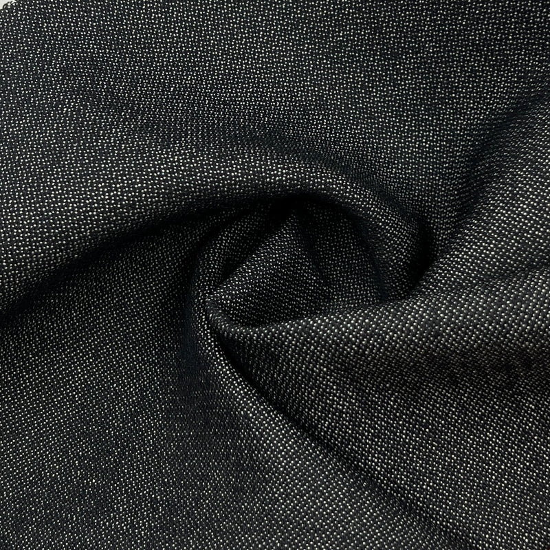 closeup of the face of a dark indigo broken twill weave denim showing the rich depth of color