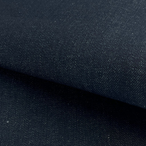 Close-up of dark blue denim fabric with a subtle texture.
