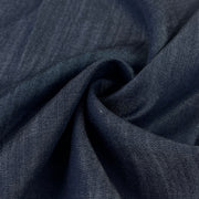 Close-up of dark indigo 100% tencel denim fabric with a subtle sheen