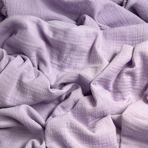Close-up of soft, light purple bubble gauze fabric with a textured surface weave.