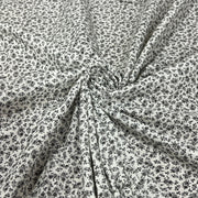 Soft cotton lawn featuring a small floral (or ditsy) print in fine black detail