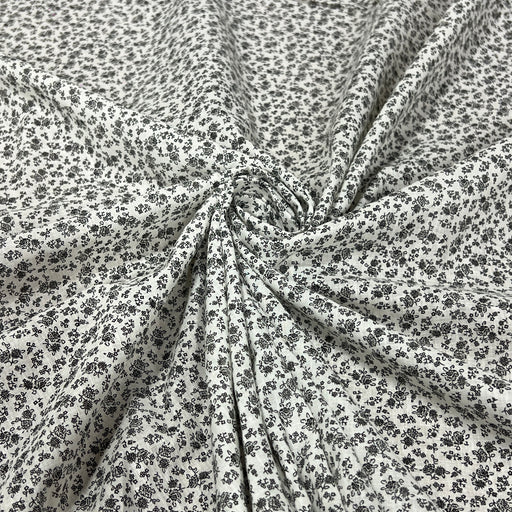 Soft cotton lawn featuring a small floral (or ditsy) print in fine black detail