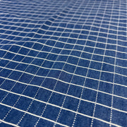 Close-up of blue fabric with white grid pattern