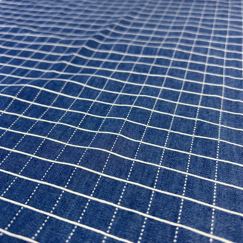Close-up of blue fabric with white grid pattern