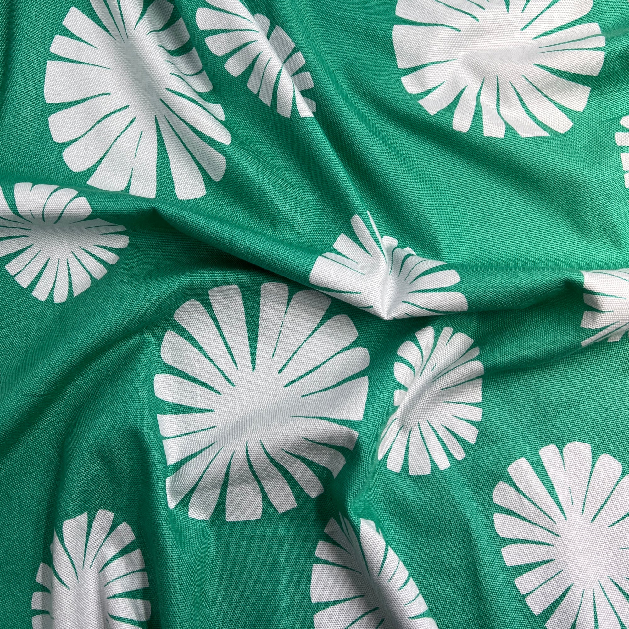 Green fabric with white floral patterns