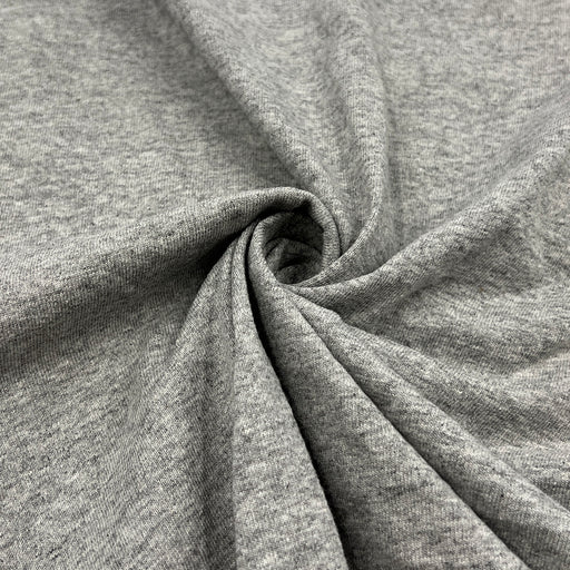 Close-up of gray cotton jersey pulled into a swirl to show off drape. 