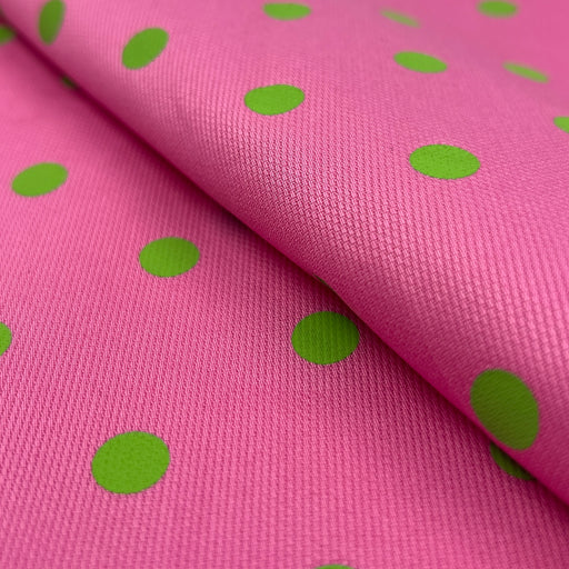 Pink fabric with green polka dots