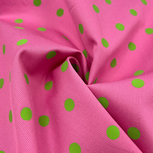 Pink fabric with green polka dots