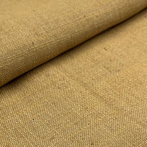 Close-up of mustard  yellow fabric with a textured pattern