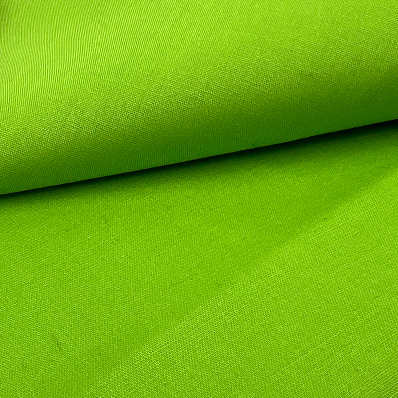 Closeup of a cotton/polyester broadcloth fabric in a bold, lime green color