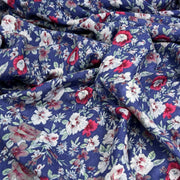 Floral fabric with red, white, and blue flowers on a blue background