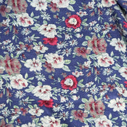 Floral patterned fabric with red, white, and green flowers on a blue background