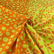 Fabric with orange and green polka dot and floral patterns