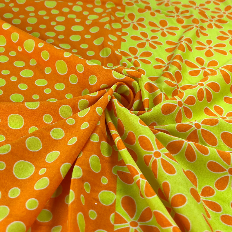 Fabric with orange and green polka dot and floral patterns