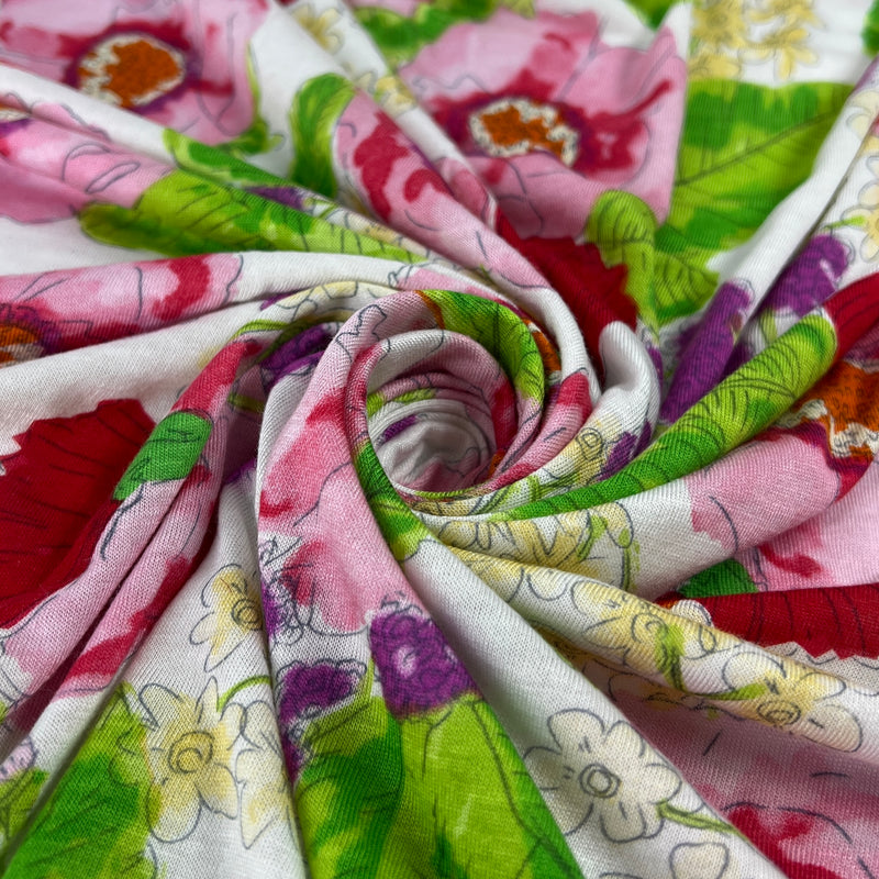 Roll of floral fabric with pink, green, and red flowers.