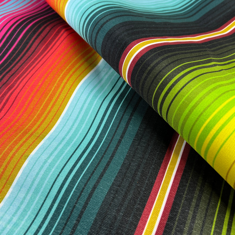 Close-up of colorful striped outdoor waterproof canvas fabric with a pattern of multicolored lines.