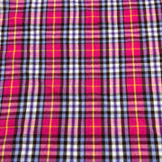 Plaid fabric with pink, purple, and yellow pattern laid flat to show pattern