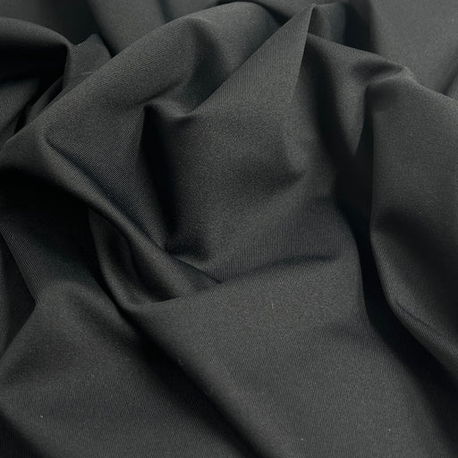 Close-up of dark gray fabric with folds