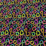 A seamless pattern of hand-drawn, colorful hearts in neon pink, yellow, blue, green, and orange on a black background.