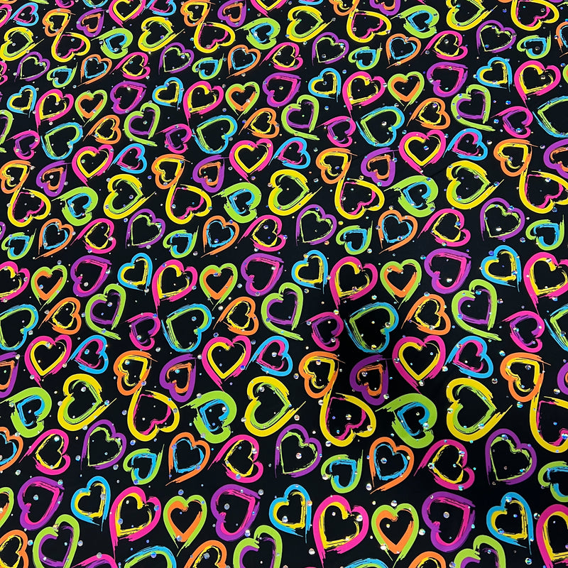 A seamless pattern of hand-drawn, colorful hearts in neon pink, yellow, blue, green, and orange on a black background.